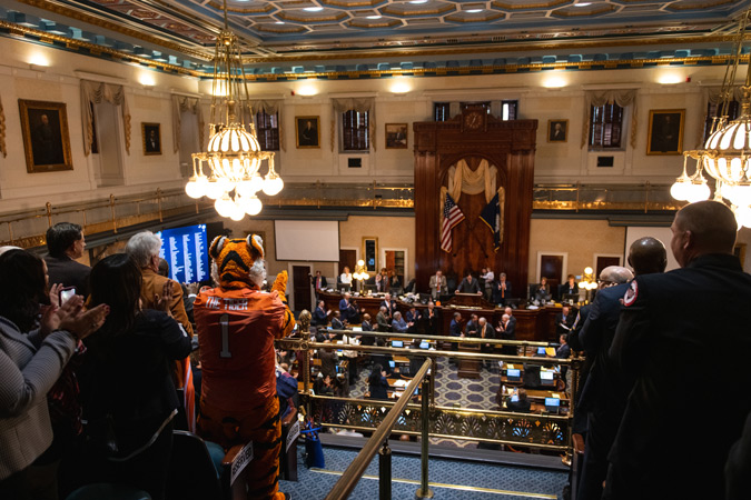 The Clemson tiger mascot stands among the crowd in the balcony above the South Carolina state Legislature's chamber. 