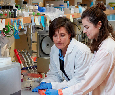 A student and professor work together in a lab