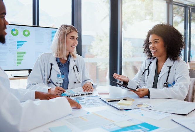 Clemson health professionals gathered around a table and having a meeting