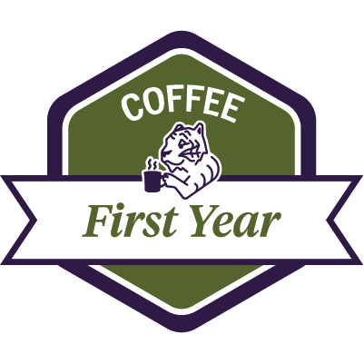 Sample green COFFEE First Year badge featuring a tiger drinking coffee.