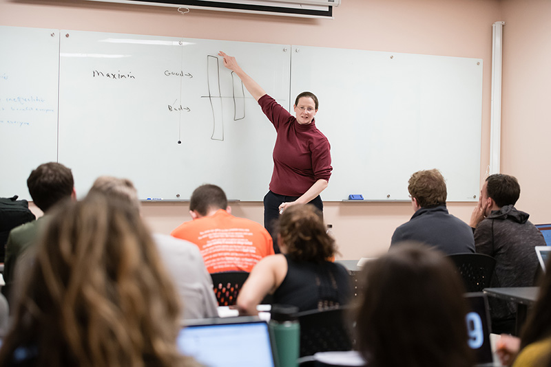 Professor in the front of a classroom.