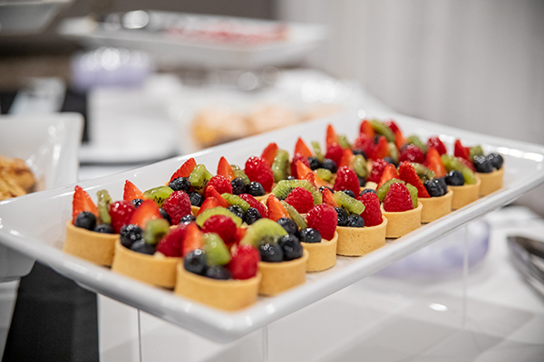 Platter of fruit topped desserts for catered event