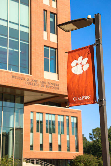 A banner reading Clemson University with a tiger paw is displayed on a light pole