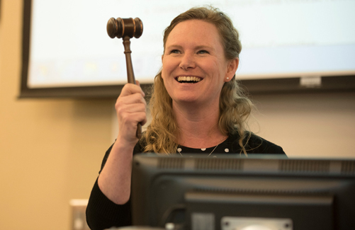 Faculty senate member with gavel.