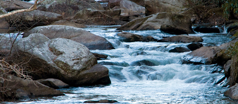 water rushing down a river over some rocks