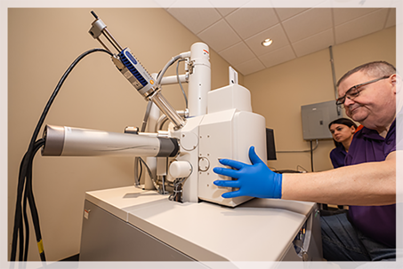 researcher holding a microscope