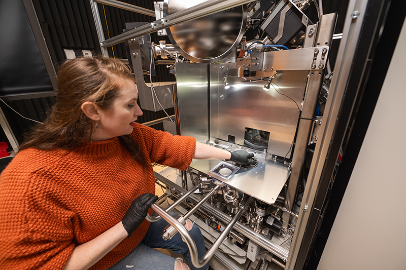 scientist with tof-sims microscope