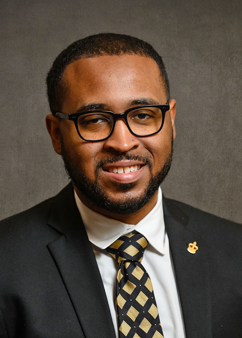 Headshot of man, Gerron Scott, in a suit.