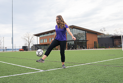 Ashley Schmidt kicking Soccer Ball at Champions Field, Snow Family Outdoor Activities and Wellness Center