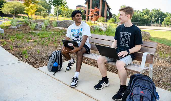 Students converse in front of Samuel J. Cadden Chapel