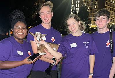 Clemson Students enjoying at U-NITES! event with a deer fawn