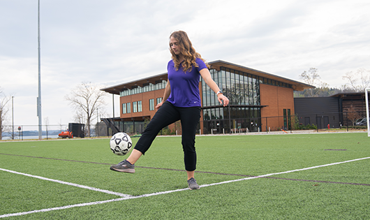 Ashley Schmidt kicking Soccer Ball at Champions Field, Snow Family Outdoor Activities and Wellness Center