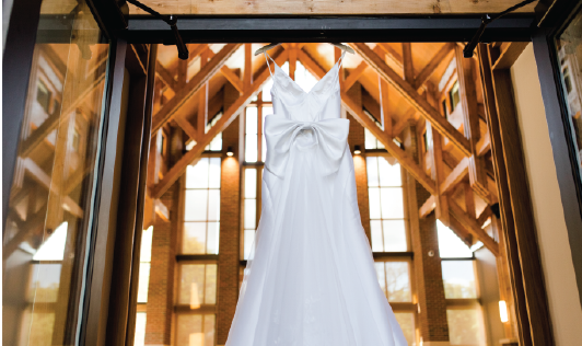 Wedding dress hanging from the doorway of the Samuel J. Cadden Chapel assembly room. 