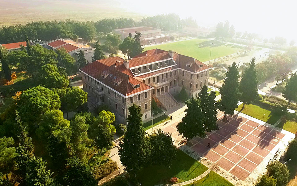 Brick building with steps and courtyard in green field